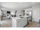 Bright kitchen area with stainless steel appliances and island seating overlooks the living space at 9537 Crossfield Rd, Avon, IN 46123