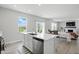 Bright kitchen island featuring stainless steel dishwasher with open concept living and dining area at 9537 Crossfield Rd, Avon, IN 46123