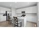 Modern kitchen boasts white cabinets, stainless steel appliances, and a central island with seating at 9537 Crossfield Rd, Avon, IN 46123