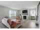 Inviting living room with a cozy fireplace, large windows, and stylish decor at 9537 Crossfield Rd, Avon, IN 46123