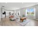 Bright and airy living room leading into an open kitchen and dining area with lots of natural light at 9537 Crossfield Rd, Avon, IN 46123