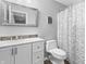 Clean bathroom featuring a vanity with double sinks and a floral shower curtain at 9709 Prairie Smoke Dr, Noblesville, IN 46060