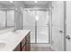 Bathroom featuring double sinks, granite counters, modern fixtures, and walk in shower at 9709 Prairie Smoke Dr, Noblesville, IN 46060