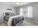 Stylized bedroom featuring a ceiling fan, large window, and decorative shelving at 9709 Prairie Smoke Dr, Noblesville, IN 46060
