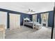 Stylish bedroom with dark blue accent wall, white furniture, and neutral carpet at 9709 Prairie Smoke Dr, Noblesville, IN 46060
