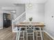 The dining room features a wooden table with decorative seating, laminate flooring and natural lighting at 9709 Prairie Smoke Dr, Noblesville, IN 46060