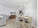 Bright dining room features a wooden table with modern chairs, laminate flooring and open concept design at 9709 Prairie Smoke Dr, Noblesville, IN 46060