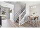Entryway with stairs, laminate floors, decorative table with chairs, front door and neutral colors at 9709 Prairie Smoke Dr, Noblesville, IN 46060