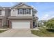 Well-kept townhome with a two-car garage and landscaping against a blue sky at 9709 Prairie Smoke Dr, Noblesville, IN 46060