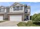 Charming two-story townhome featuring an attached garage and landscaped front yard at 9709 Prairie Smoke Dr, Noblesville, IN 46060