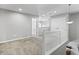 Spacious hallway with neutral walls, plush carpet, and white trim at 9709 Prairie Smoke Dr, Noblesville, IN 46060