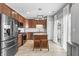 Well-equipped kitchen featuring stainless steel appliances, center island, and access to outdoor patio at 9709 Prairie Smoke Dr, Noblesville, IN 46060