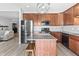 Well-equipped kitchen boasts stainless steel appliances, wood cabinets, granite countertop island, and open concept design at 9709 Prairie Smoke Dr, Noblesville, IN 46060