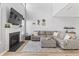 Bright and airy living room with a fireplace, large sectional sofa, and modern decor at 9709 Prairie Smoke Dr, Noblesville, IN 46060
