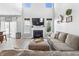 Spacious living room with high ceilings, fireplace, open layout, and comfortable sectional seating at 9709 Prairie Smoke Dr, Noblesville, IN 46060