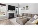 Inviting living room featuring a modern fireplace, TV, comfortable seating, and stylish decor at 9709 Prairie Smoke Dr, Noblesville, IN 46060