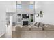 This living room offers a fireplace, large windows, and a vaulted ceiling at 9709 Prairie Smoke Dr, Noblesville, IN 46060