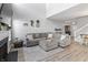 Spacious living room with high ceilings, modern decor, fireplace, and open layout to the kitchen at 9709 Prairie Smoke Dr, Noblesville, IN 46060