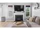 Cozy living room showcasing a fireplace with large windows, providing ample natural light at 9709 Prairie Smoke Dr, Noblesville, IN 46060