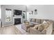 Bright living room with modern fireplace, mounted TV, and comfortable sectional sofa at 9709 Prairie Smoke Dr, Noblesville, IN 46060