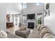 Open-concept living room featuring high ceilings, a fireplace, and seamless flow to the kitchen at 9709 Prairie Smoke Dr, Noblesville, IN 46060