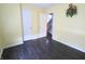 Empty bedroom with pale yellow walls, dark floors, and view of stairs at 10628 Bali Ct, Noblesville, IN 46060