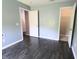 Bedroom featuring gray walls, wood-look flooring, and access to a closet at 10628 Bali Ct, Noblesville, IN 46060