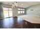 Living room with hardwood flooring and sliding glass door to access the backyard at 10628 Bali Ct, Noblesville, IN 46060