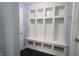 Bright mudroom with built-in storage cubbies, bench, and dark wood-look flooring at 10628 Bali Ct, Noblesville, IN 46060