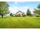 Brick house backyard with a sprawling green lawn, mature trees, and surrounding greenery, a tranquil oasis at 1105 Sarah Ct, Greenwood, IN 46142