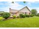 Brick house backyard showcasing a deck, well-kept lawn, and manicured bushes, ideal for relaxing at 1105 Sarah Ct, Greenwood, IN 46142
