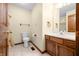 This bathroom features a toilet, vanity with sink, wood accents, and ceramic tile floors at 1105 Sarah Ct, Greenwood, IN 46142