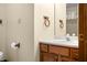 Close up of a single sink bathroom vanity with wooden cabinets, light walls, and wood towel racks at 1105 Sarah Ct, Greenwood, IN 46142