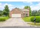 Charming brick home featuring an attached garage, well-manicured lawn, and welcoming curb appeal at 1105 Sarah Ct, Greenwood, IN 46142