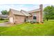 Close up of a charming brick home with a meticulously landscaped entryway with a manicured lawn at 1105 Sarah Ct, Greenwood, IN 46142