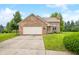 Charming brick home featuring an attached garage, well-manicured lawn, and welcoming curb appeal at 1105 Sarah Ct, Greenwood, IN 46142