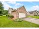 Brick home with attached garage and landscaping at 1105 Sarah Ct, Greenwood, IN 46142