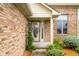 Close up of a front door featuring purple flowers, greenery and yellow flower accents at 1105 Sarah Ct, Greenwood, IN 46142