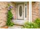 Close up of a front door featuring purple flowers, greenery and yellow flower accents at 1105 Sarah Ct, Greenwood, IN 46142