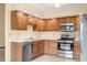 Well-lit kitchen with stainless steel appliances, wood cabinetry and durable countertops at 1105 Sarah Ct, Greenwood, IN 46142