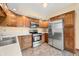 Bright kitchen featuring stainless steel appliances, abundant wood cabinets and stylish flooring at 1105 Sarah Ct, Greenwood, IN 46142