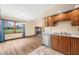 Kitchen with stainless appliances, wood cabinets adjacent to dining area and fireplace at 1105 Sarah Ct, Greenwood, IN 46142
