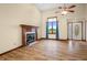 Cozy living room with a charming fireplace, large window, and laminate floors at 1105 Sarah Ct, Greenwood, IN 46142