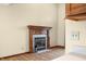 Partial living room with laminate flooring, light switch, and a traditional fireplace at 1105 Sarah Ct, Greenwood, IN 46142