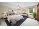 Comfortable main bedroom with neutral decor, ceiling fan, and bright windows at 1105 Sarah Ct, Greenwood, IN 46142