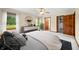Bright main bedroom features a ceiling fan, dresser and view of the manicured lawn at 1105 Sarah Ct, Greenwood, IN 46142