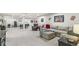 Open basement area showcasing entertainment options, including a sectional sofa and arcade games at 1107 Mccray Ln, Westfield, IN 46074
