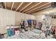 Finished basement space with exposed ceiling beams and versatile display racks for clothing and accessories at 1107 Mccray Ln, Westfield, IN 46074