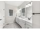 Stylish bathroom featuring double sinks, modern fixtures, and a window for natural light at 1107 Mccray Ln, Westfield, IN 46074