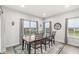 Dining room with large windows, modern decor, and a rustic wood table with seating for six at 1107 Mccray Ln, Westfield, IN 46074